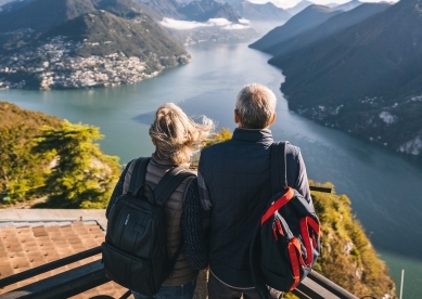 Mature couple hike above lake Lugano in the morning